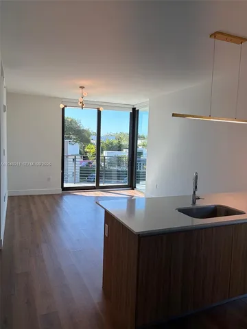 a kitchen with a sink and large window
