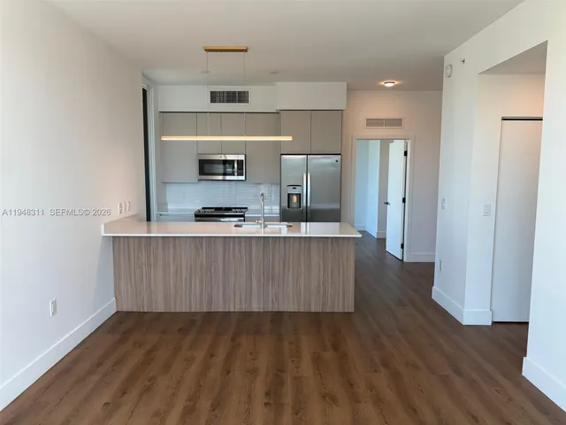 a room with wooden floor and staircase