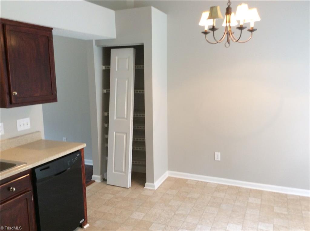 3600 Country Ridge Road Greensboro, NC 27405 - Photo 22 of 30 This is a view from the far end of the kitchen looking over toward the eating area. The folding door is to the pantry and was in process of being installed during this picture.