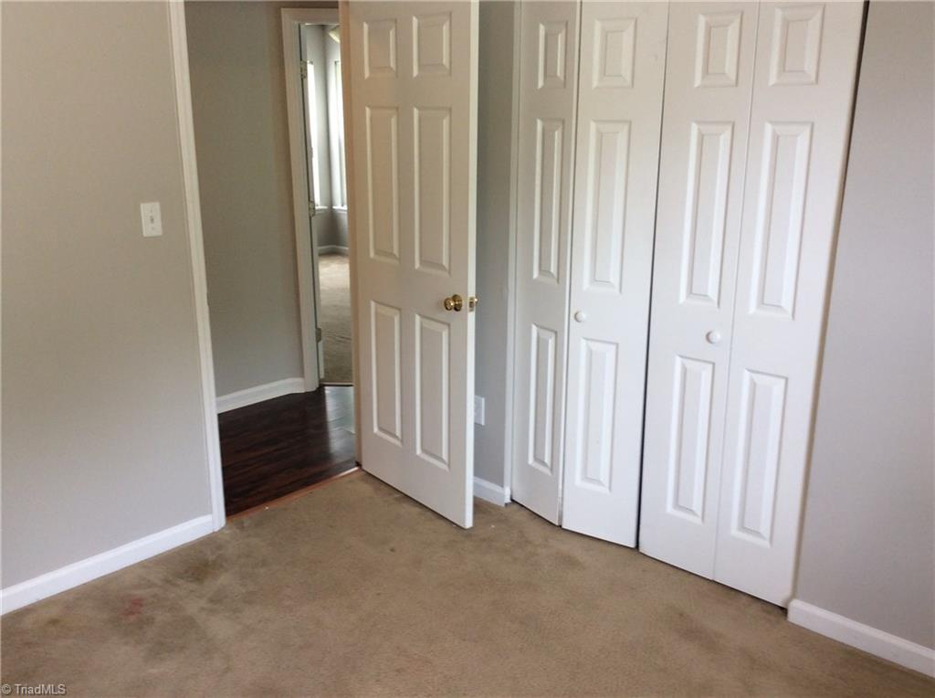 3600 Country Ridge Road Greensboro, NC 27405 - Photo 8 of 30 This is bedroom three with carpet flooring, fresh new paint, one window for natural lighting and blinds for privacy and the double door closet has wire rack shelves.