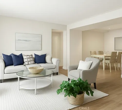 a living room with furniture a table and a potted plant