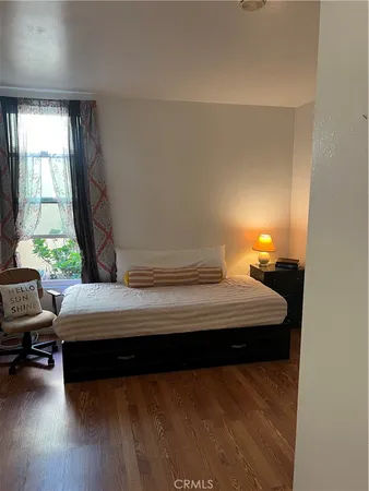 a bedroom with bed and window