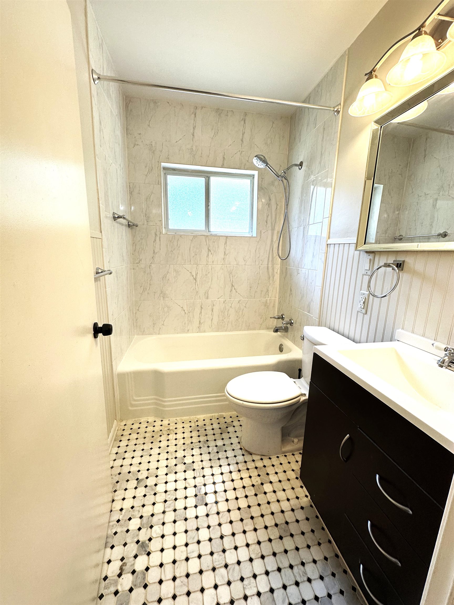 5260 Brantford Avenue Memphis, TN 38120 - Photo 13 of 23 a bathroom with a sink a toilet a mirror a bathtub and shower