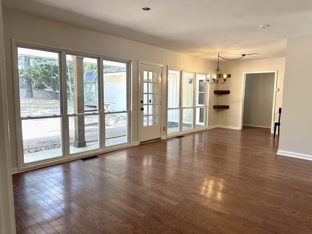 a view of an entryway with wooden floor