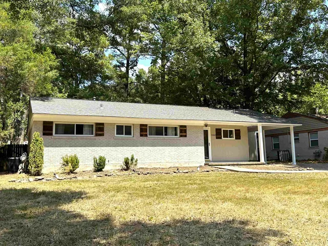a front view of a house with a swimming pool
