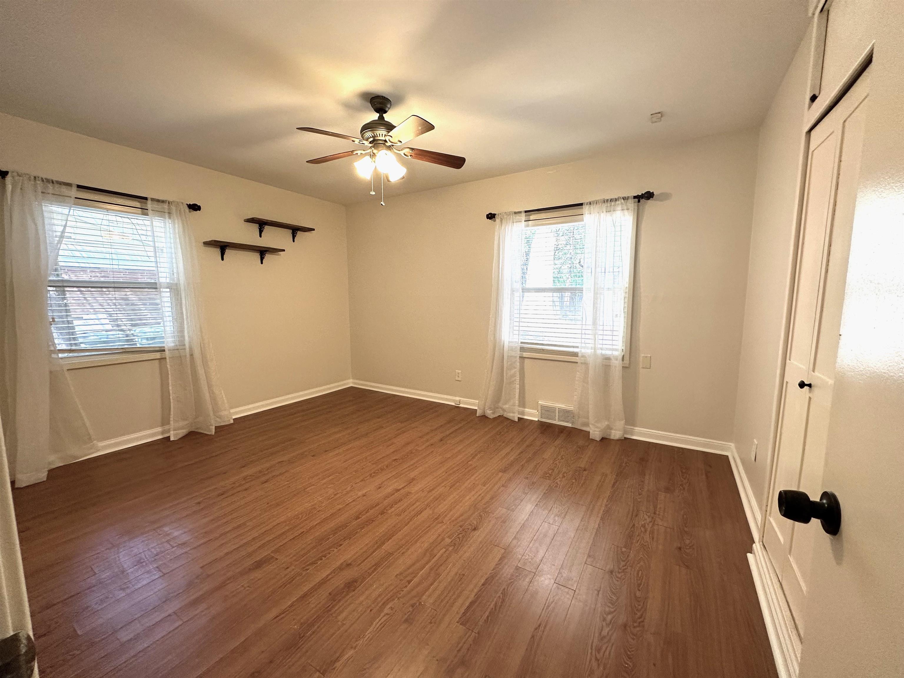 5260 Brantford Avenue Memphis, TN 38120 - Photo 21 of 23 a view of an empty room with a window and wooden floor