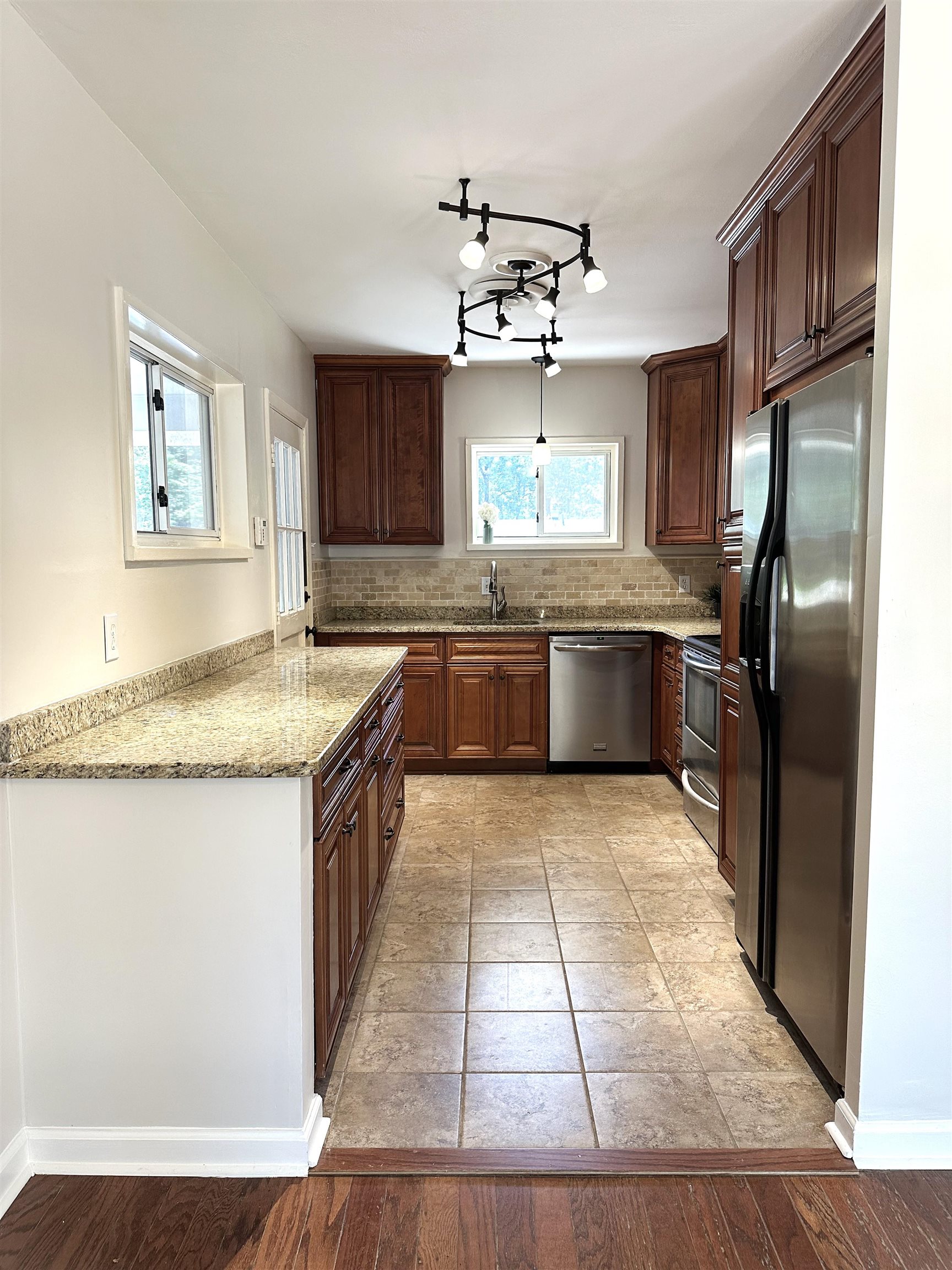 5260 Brantford Avenue Memphis, TN 38120 - Photo 6 of 23 a kitchen with stainless steel appliances granite countertop a sink stove and refrigerator