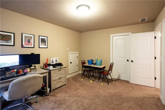 a view of a workspace with furniture and a window