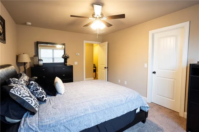 a bedroom with a bed and dresser with mirror