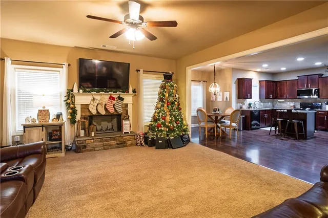 a view of a livingroom with furniture a flat screen tv and floor to ceiling window