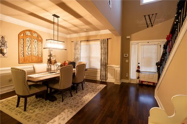 a dining room with furniture window and wooden floor