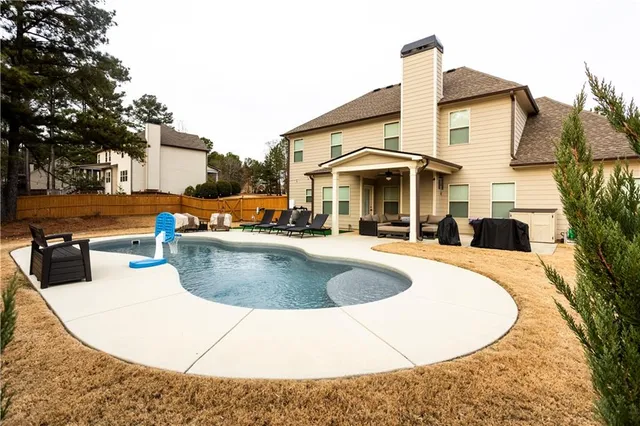 a view of a swimming pool with a patio