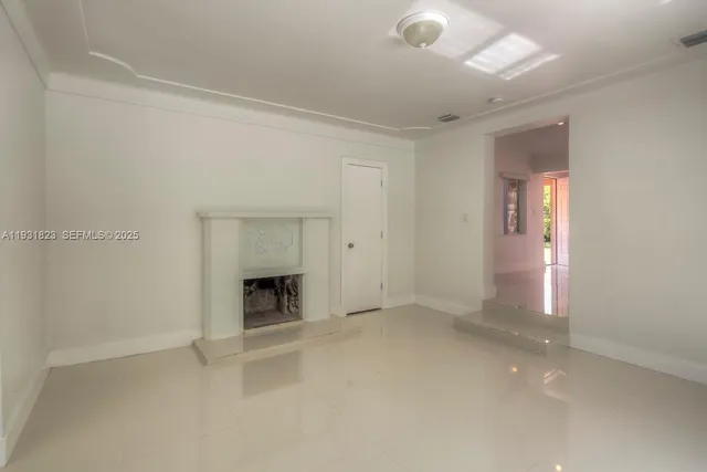 a view of empty room with a fireplace