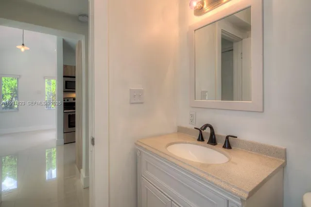 a view of a backyard with plants and large tree