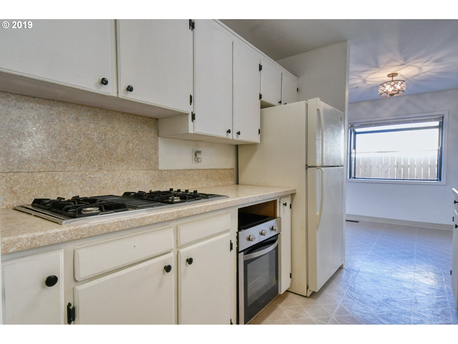 2406 Southwest Olson Avenue Pendleton, OR 97801 - Photo 10 of 32 a kitchen with granite countertop a stove a refrigerator and a sink