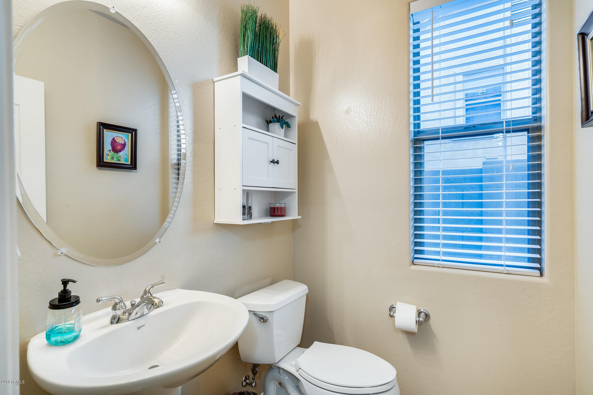 2028 West Caleb Road Phoenix, AZ 85085 - Photo 27 of 57 a bathroom with a toilet a sink and mirror