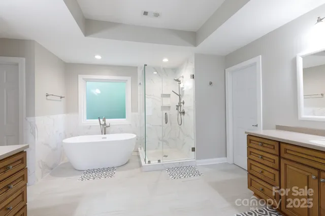 a bathroom with double vanity sinks and a mirror