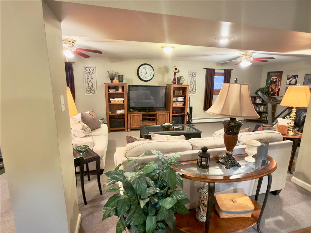 4982 Abbey Road Coplay, PA 18037 - Photo 42 of 55 An open basement family room features plush carpeting and custom wood built-in shelving.