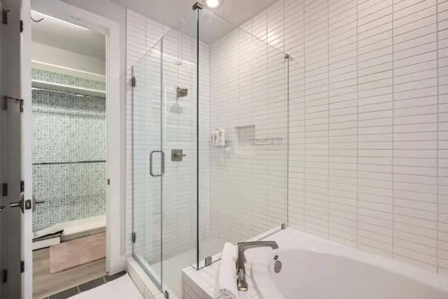 a bathroom with a bathtub and a shower