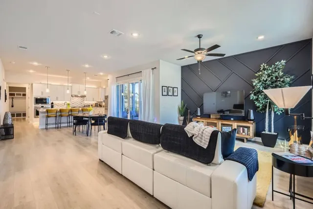 a living room with furniture and kitchen view