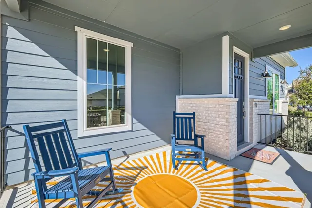 a view of a patio with a table and chairs and wooden floor