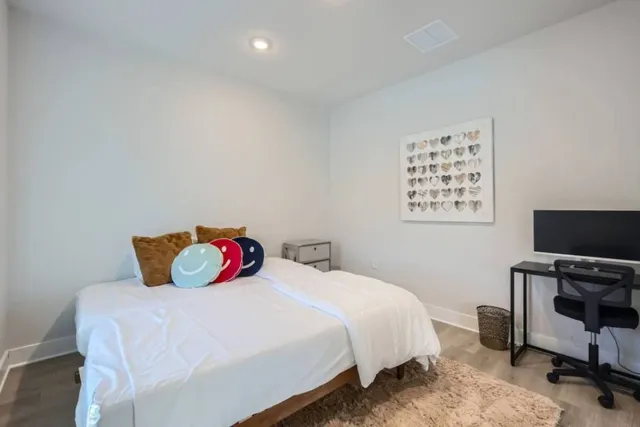 a bedroom with a bed and a flat screen tv