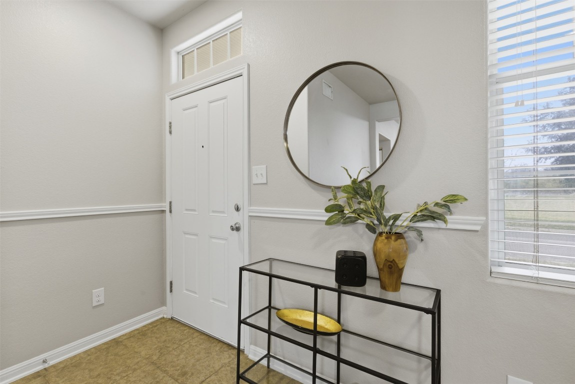 413 Shadow Point San Marcos, TX 78666 - Photo 3 of 34 At the entry you'll be met with an inviting aesthetic featuring a beautiful chair rail.