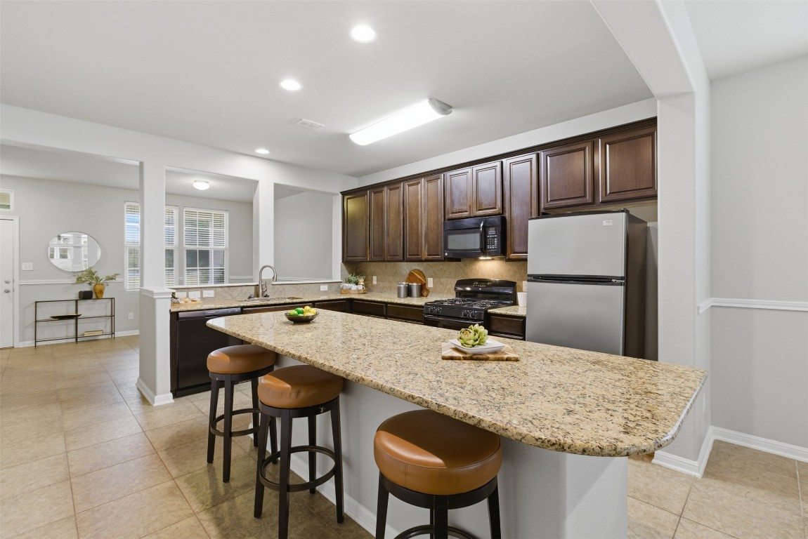413 Shadow Point San Marcos, TX 78666 - Photo 7 of 34 From the front room, you'll quickly find the kitchen in the heart of the home.