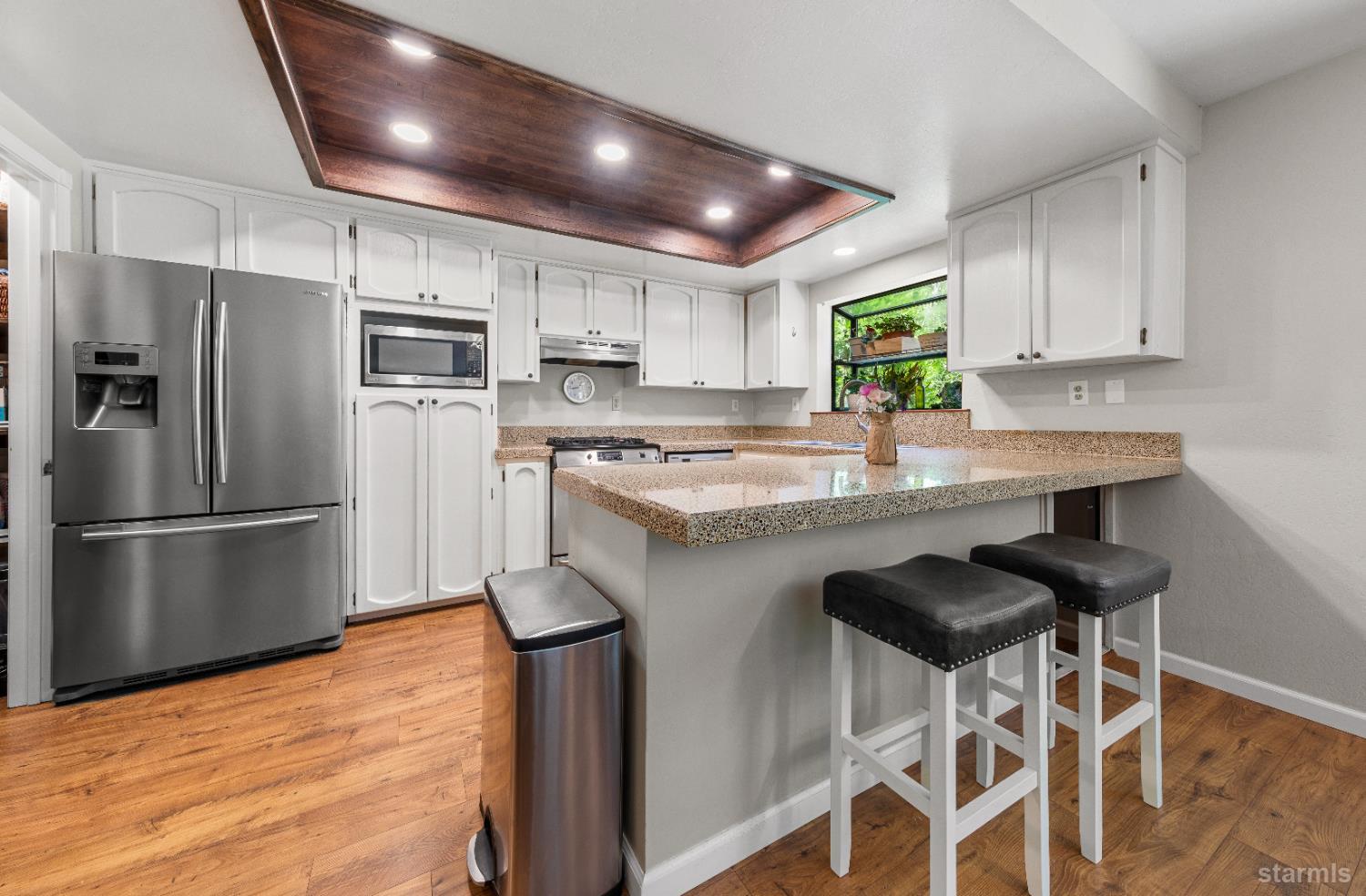 1121 Sundown Trail South Lake Tahoe, CA 96150 - Photo 12 of 40 a kitchen with stainless steel appliances granite countertop a stove refrigerator sink and cabinets