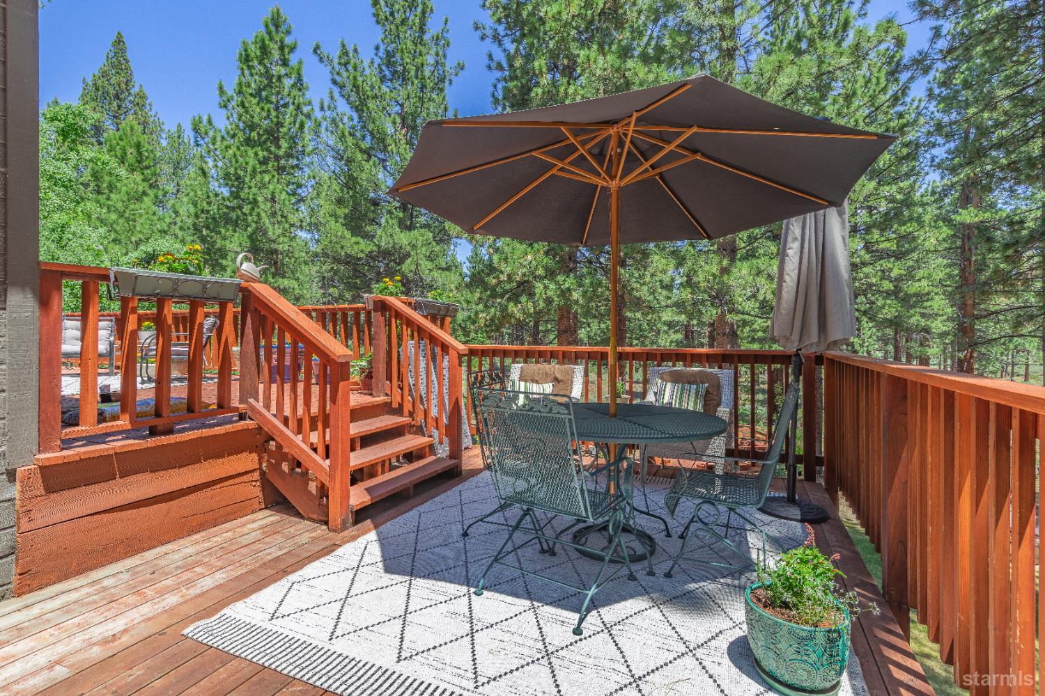 1121 Sundown Trail South Lake Tahoe, CA 96150 - Photo 15 of 40 a view of a deck with furniture under an umbrella