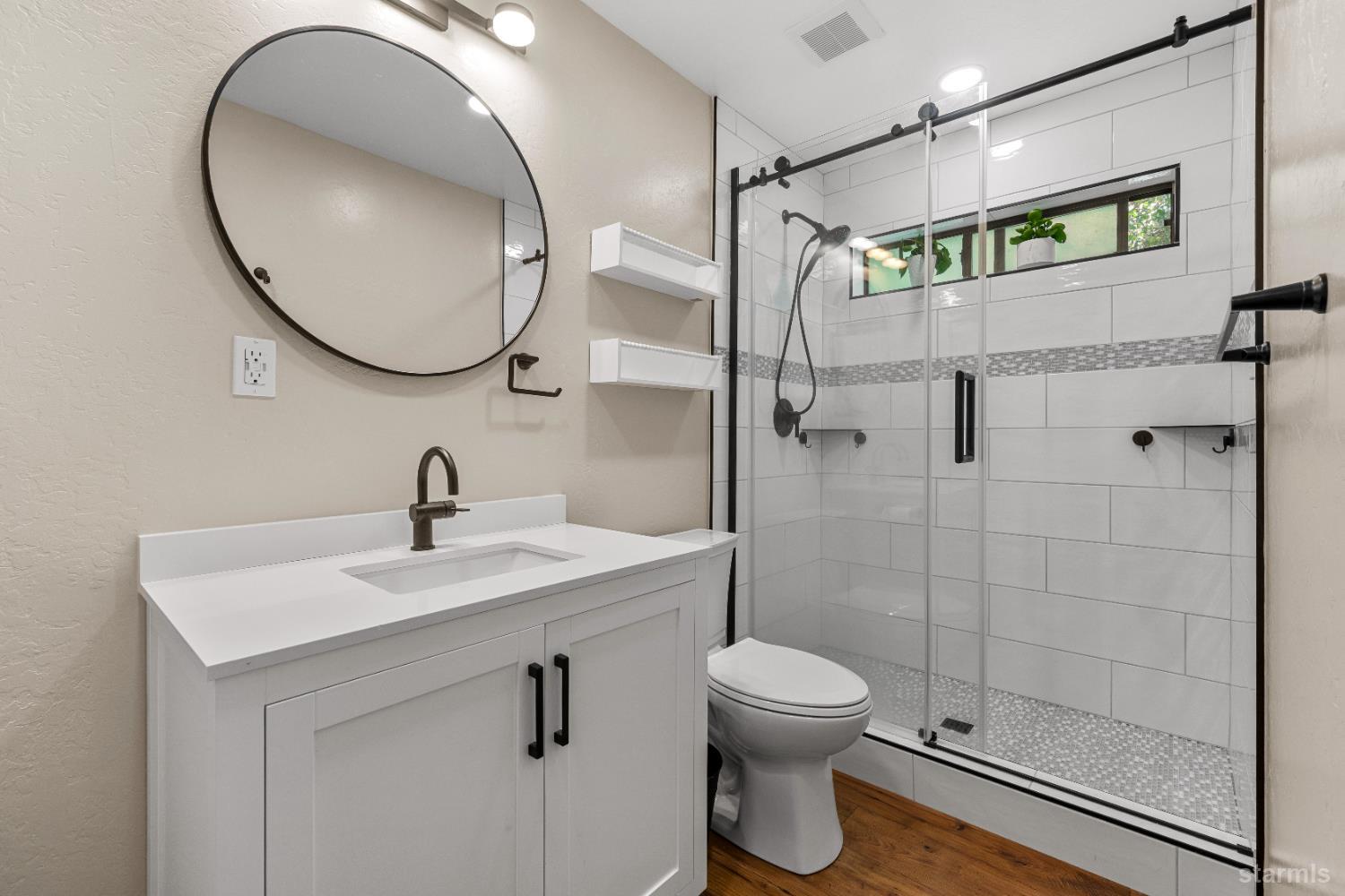 1121 Sundown Trail South Lake Tahoe, CA 96150 - Photo 20 of 40 a bathroom with a sink a toilet and a mirror