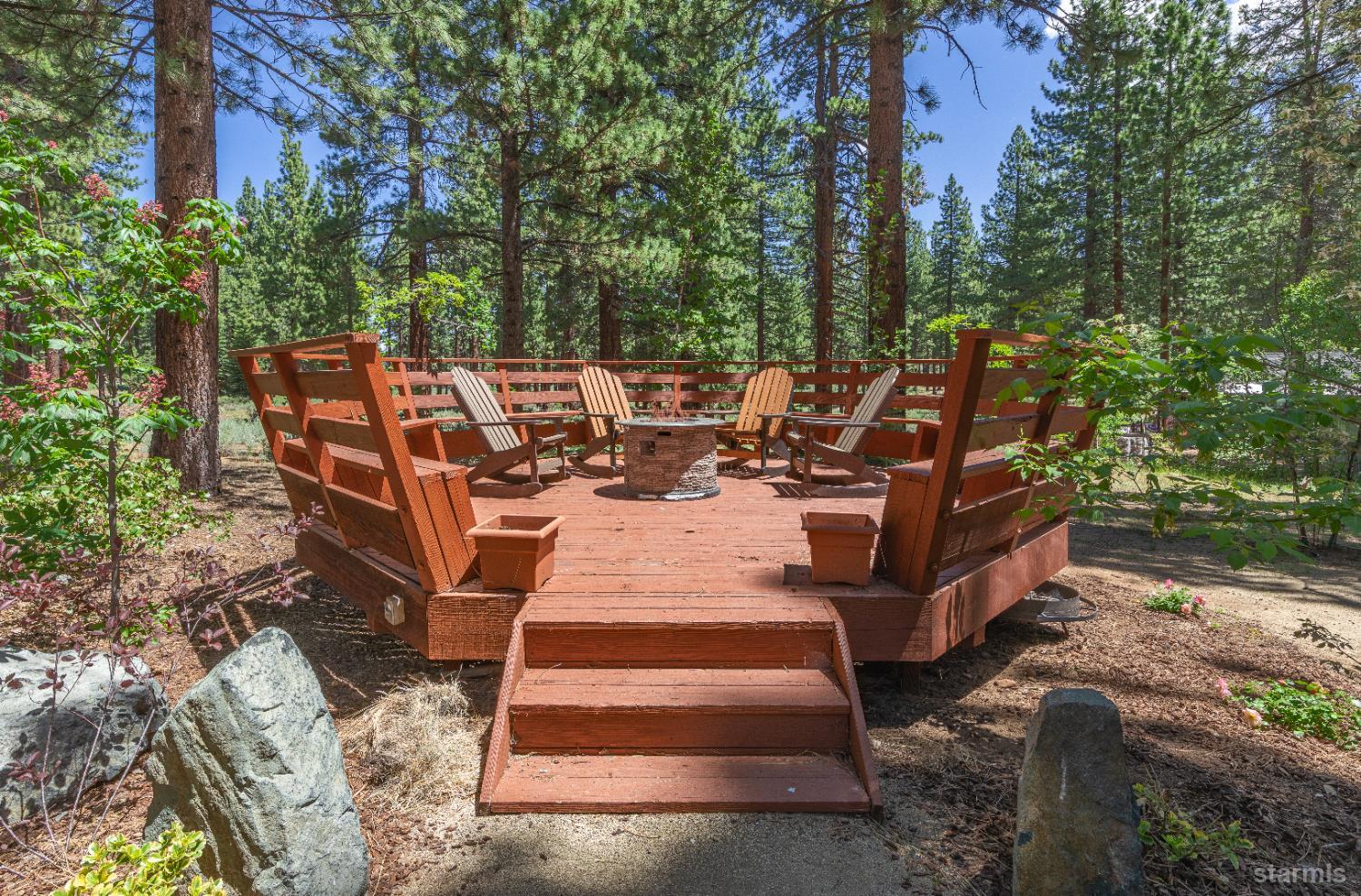 1121 Sundown Trail South Lake Tahoe, CA 96150 - Photo 30 of 40 a view of a patio with table and chairs plants and large trees
