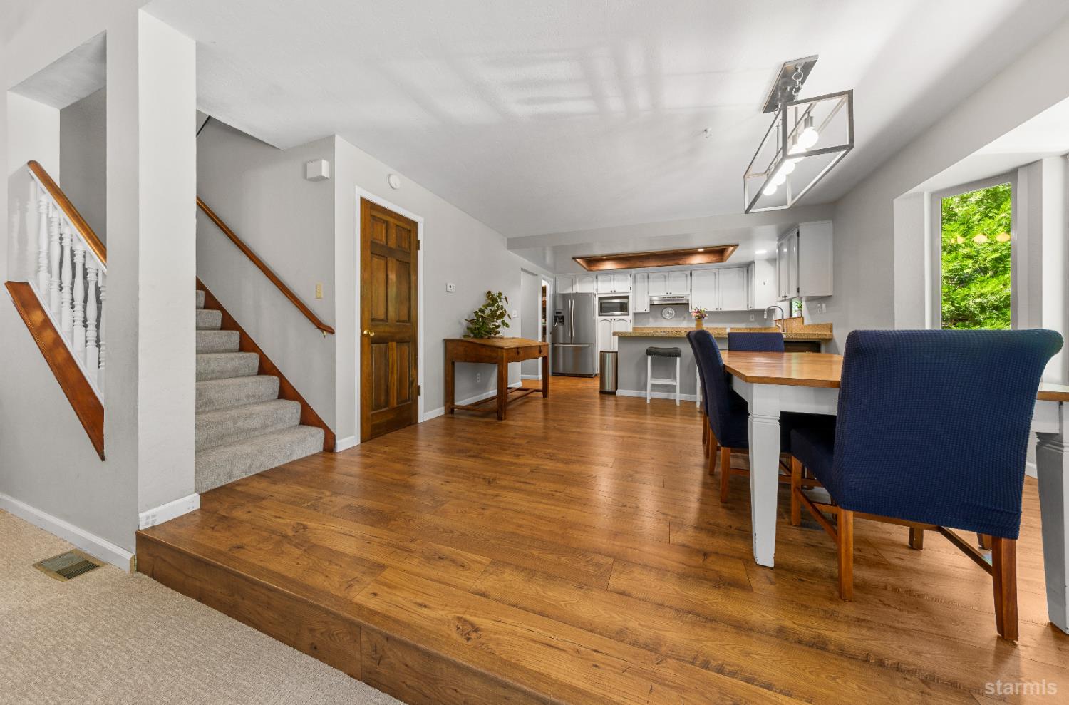 1121 Sundown Trail South Lake Tahoe, CA 96150 - Photo 9 of 40 a living room with furniture wooden floor dining table and a large window