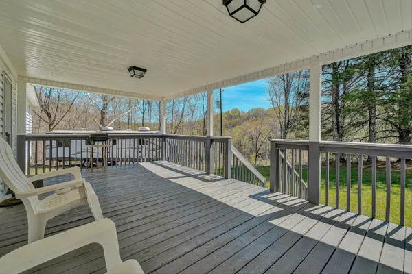 a view of a balcony with wooden floor and outdoor space