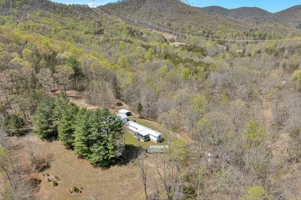a view of a dry yard with mountains in the background