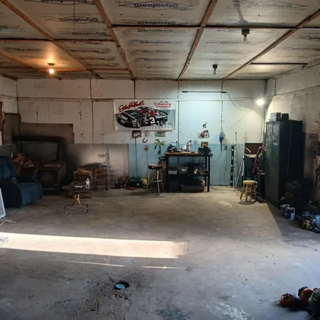 a garage with furniture and a flat screen tv