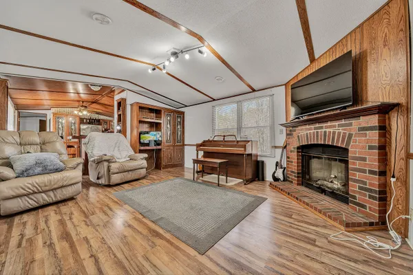a living room with furniture a flat screen tv and a fireplace