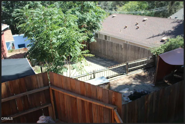 a wooden fence with trees in the background