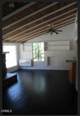 a view of a room with an empty space and a window