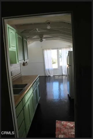 a kitchen with granite countertop a sink and a stove