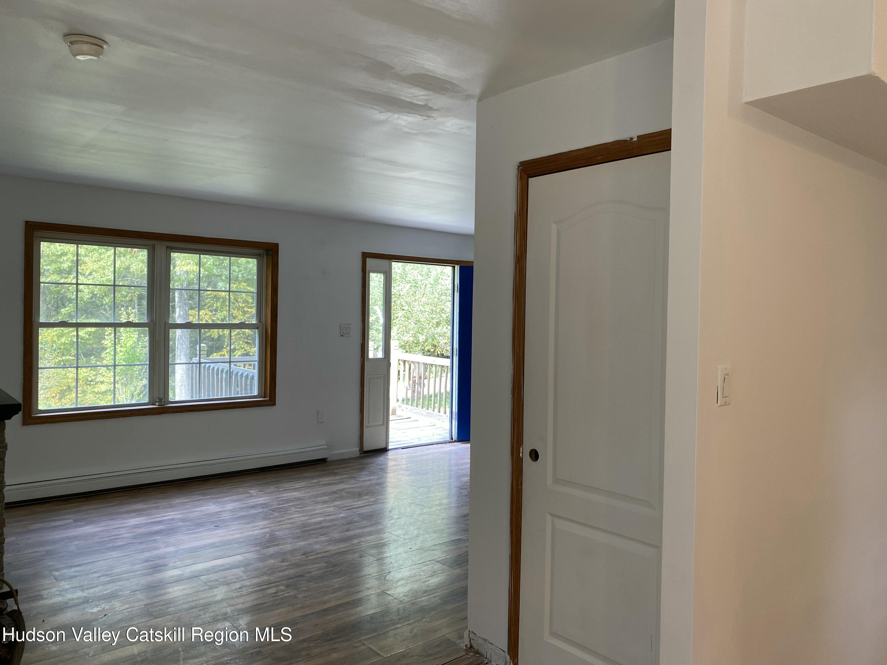 83 Buffalo Road Saugerties, NY 12477 - Photo 4 of 54 a view of an empty room with wooden floor and a window
