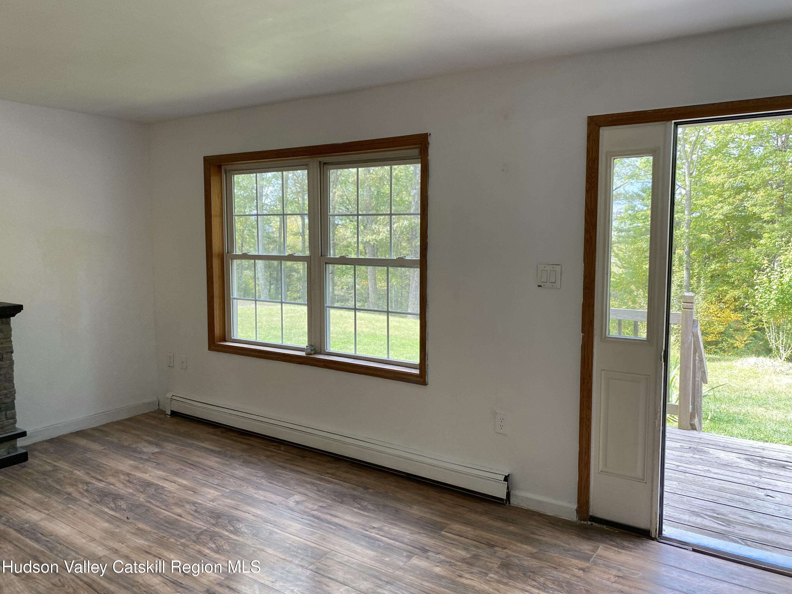 83 Buffalo Road Saugerties, NY 12477 - Photo 8 of 54 a view of an empty room with wooden floor and a window