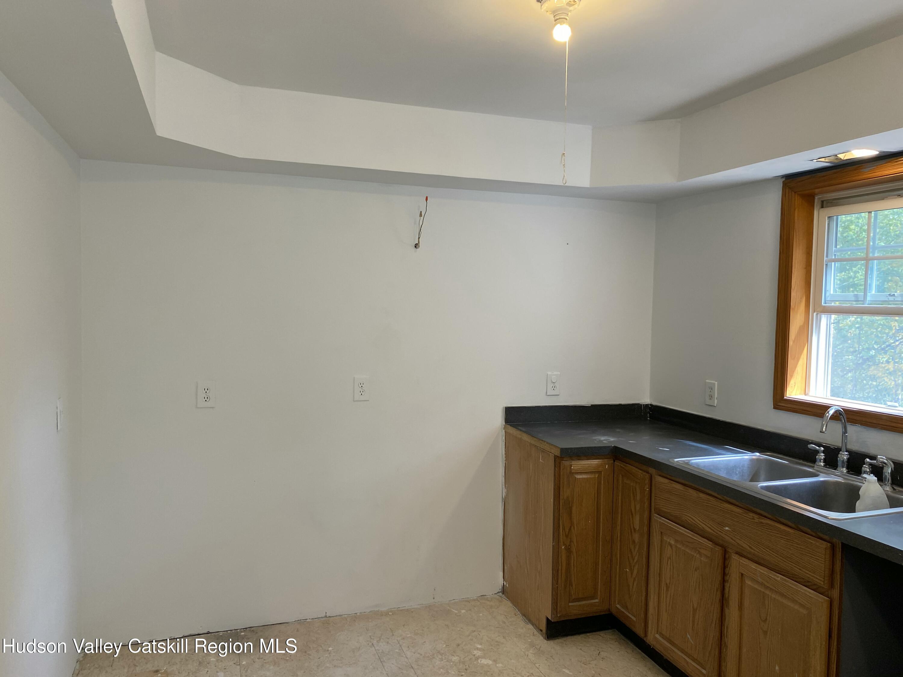 83 Buffalo Road Saugerties, NY 12477 - Photo 9 of 54 a room with a sink cabinets and a window