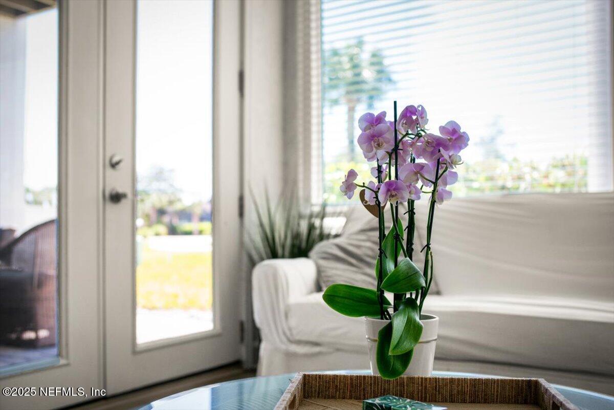 25 Tifton Way South Ponte Vedra Beach, FL 32082 - Photo 12 of 59 a vase of flowers sitting on a table with a window