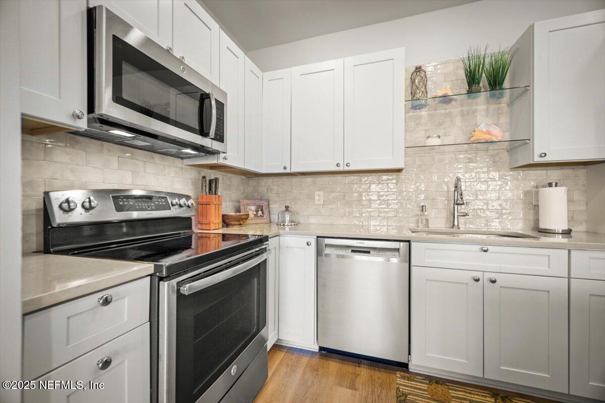 25 Tifton Way South Ponte Vedra Beach, FL 32082 - Photo 21 of 59 a kitchen with cabinets stainless steel appliances and wooden floor