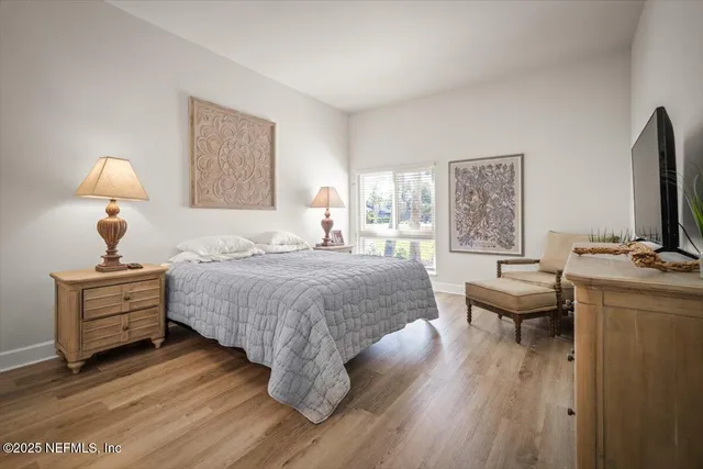 a bedroom with a bed and a painting on the wall