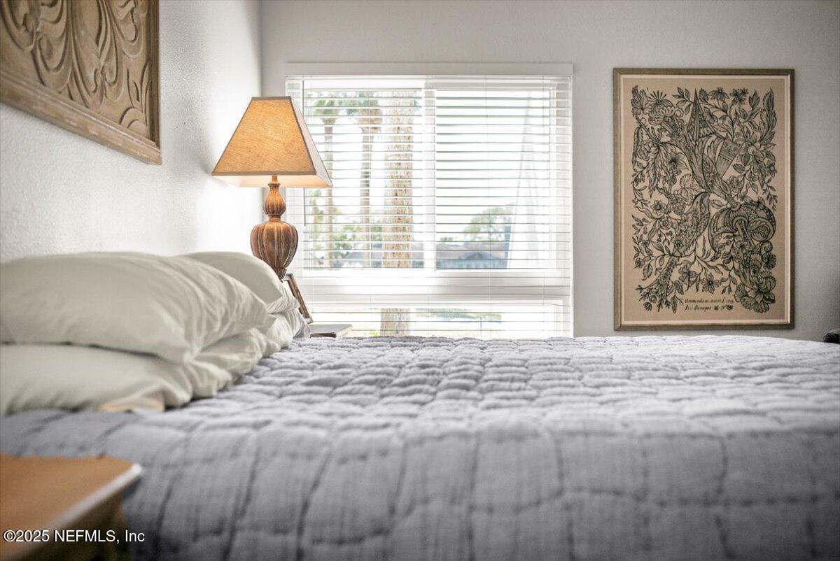 25 Tifton Way South Ponte Vedra Beach, FL 32082 - Photo 28 of 59 a bedroom with a bed and a couch