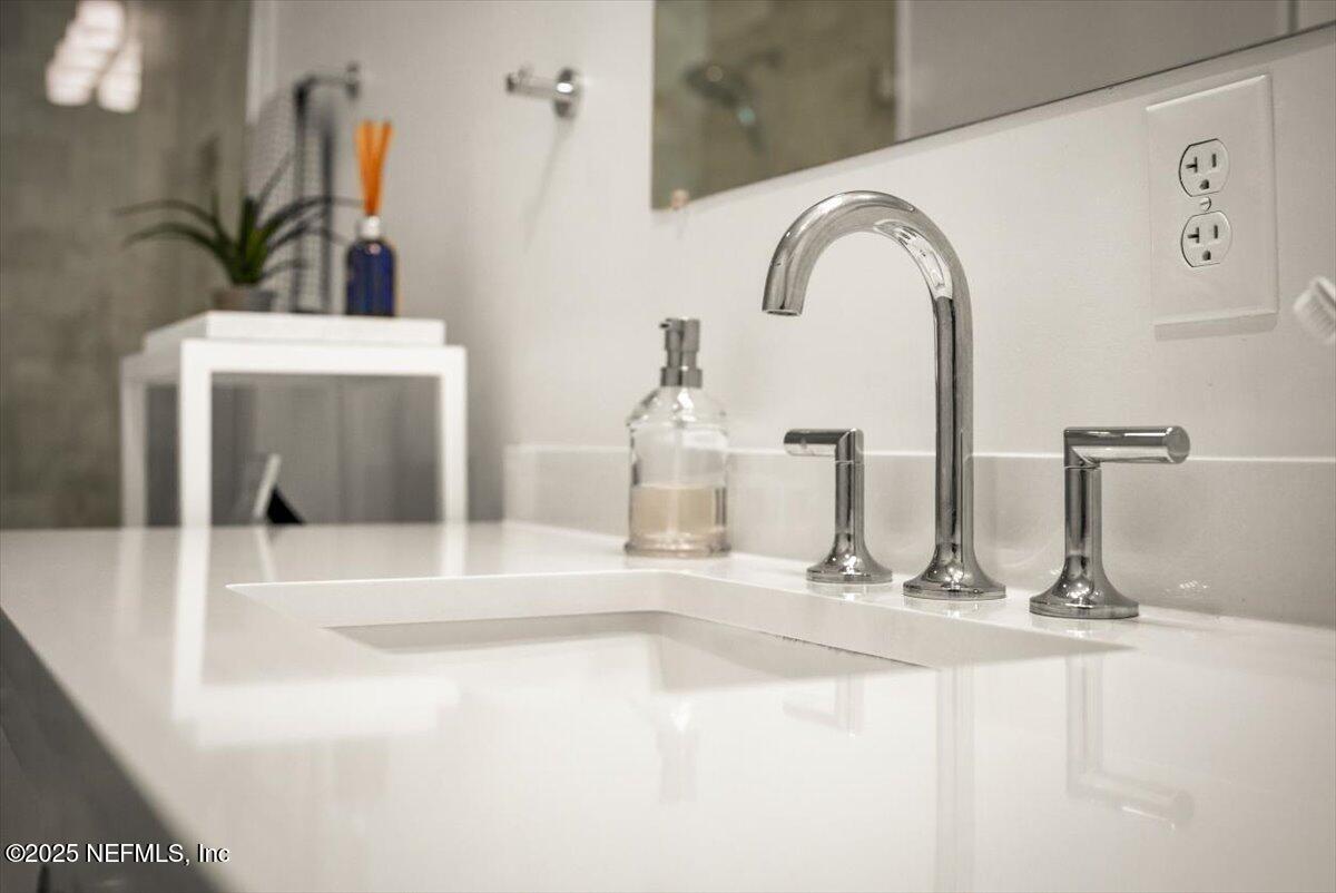 25 Tifton Way South Ponte Vedra Beach, FL 32082 - Photo 30 of 59 a bathroom with a sink and a mirror