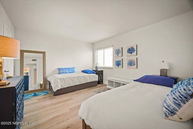 a patio table and chairs with potted plants