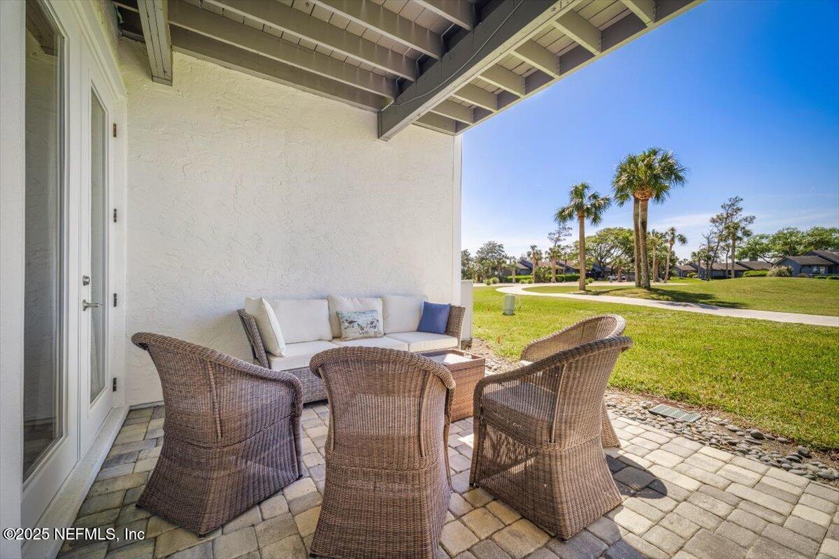 25 Tifton Way South Ponte Vedra Beach, FL 32082 - Photo 38 of 59 a patio table and chairs with potted plants